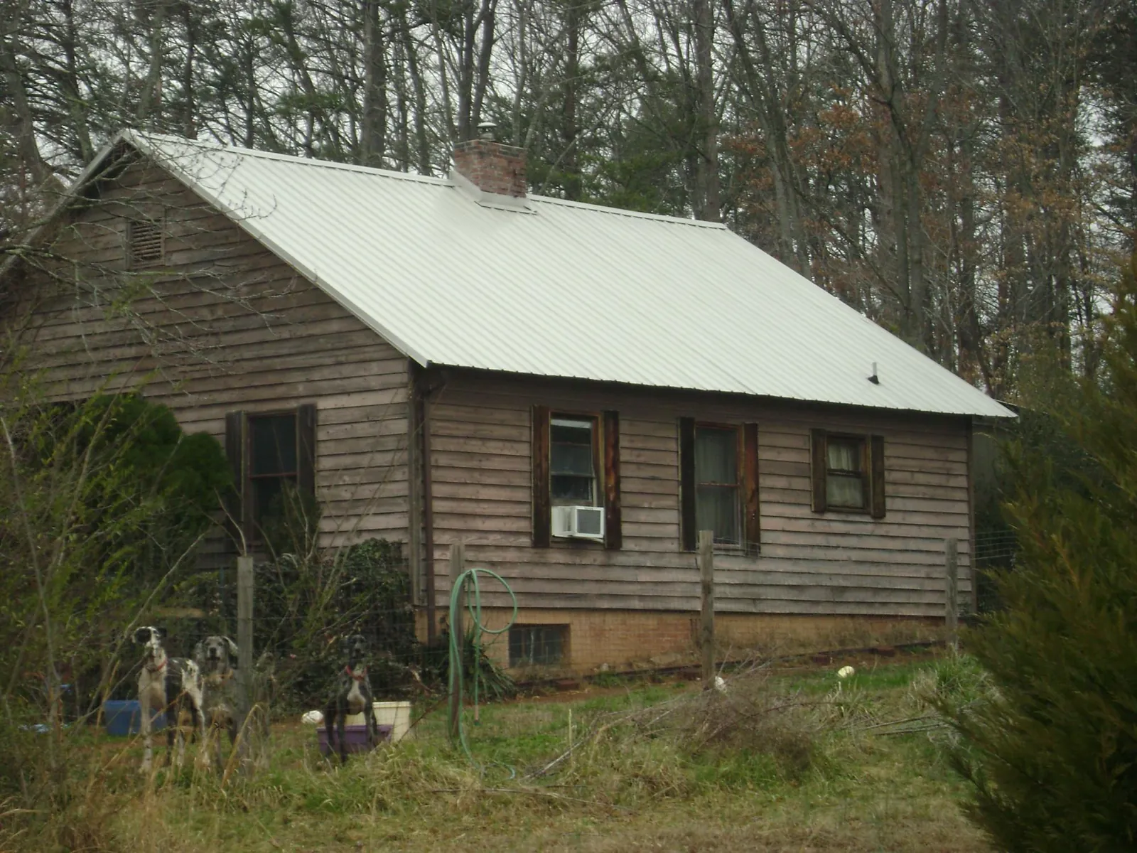 White metal roof on an old wood sided farmhouse, from a Metal Roof Installation job in North Royalton